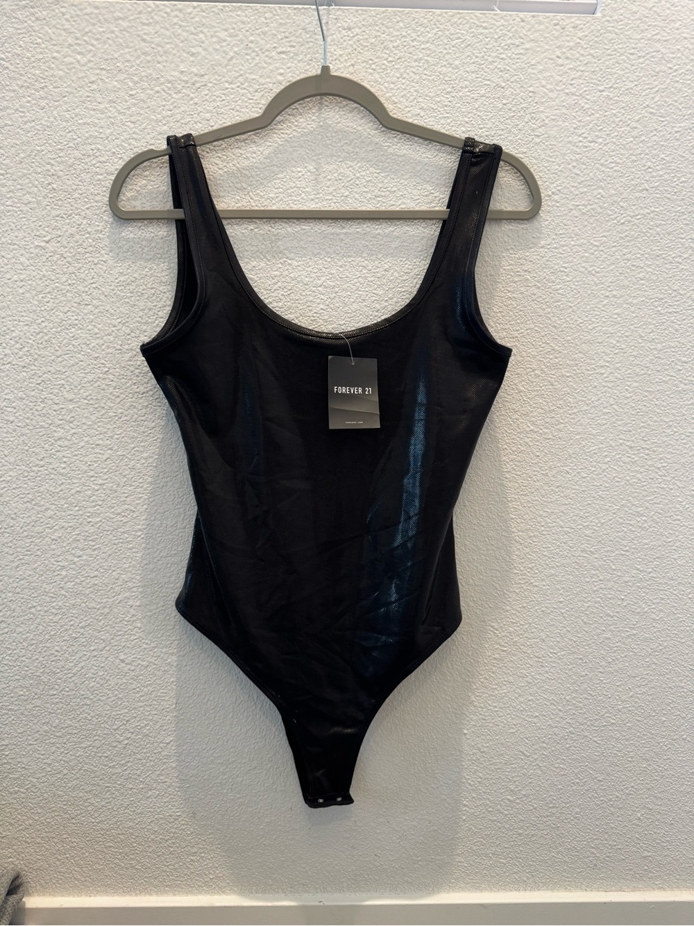 NWT Forever 21 black scoop-neck sleeveless bodysuit w/ sleek, glossy finish.